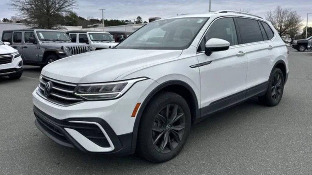 Certified Pre-Owned Volkswagen Tiguan SUV white exterior front three quarter view on dealership lot.