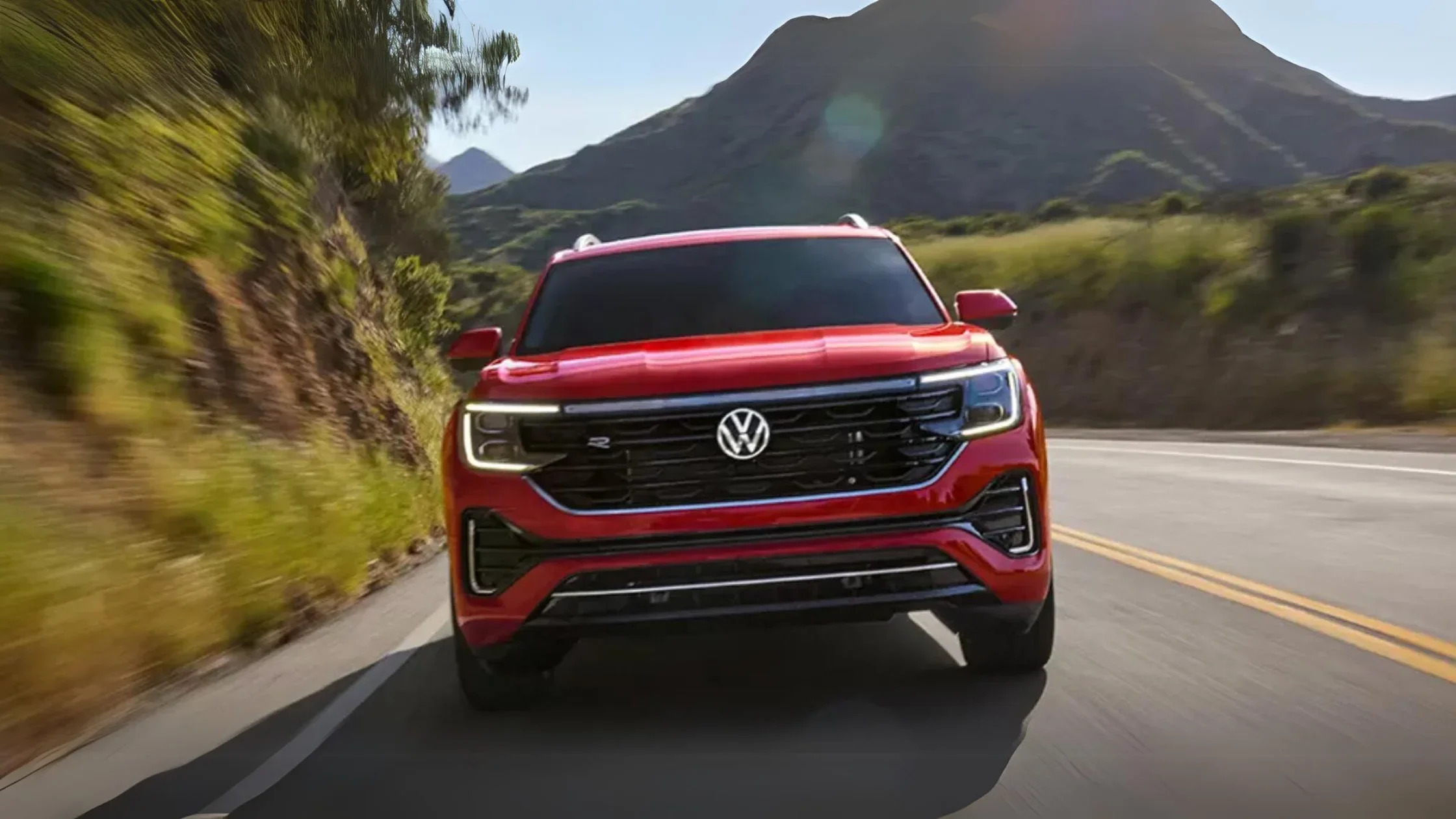 The 2020 Volkswagen Atlas drives along a winding mountain road