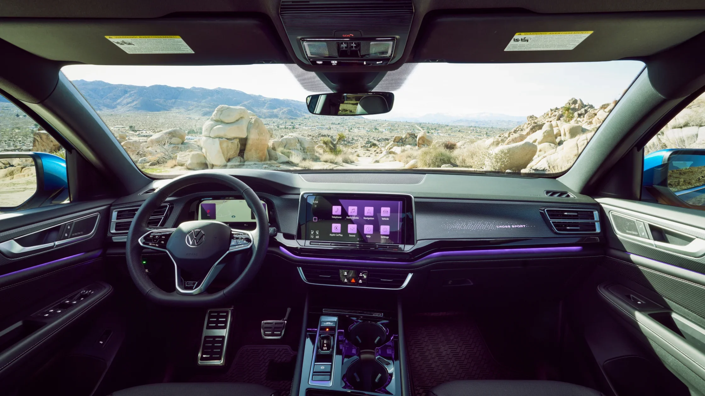 2024 Volkswagen Atlas Cross Sport interior with digital display and mountain view.