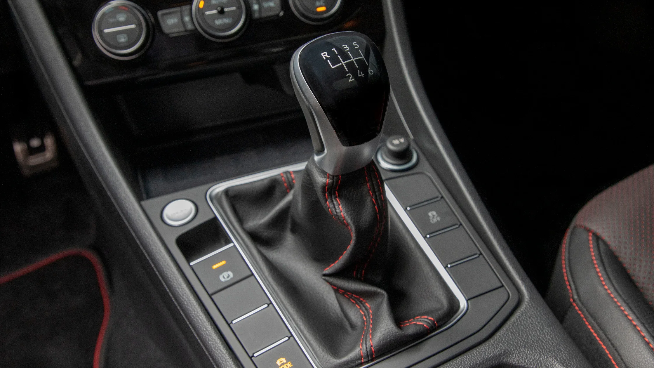 2024 Volkswagen Jetta GLI manual gear shift with red stitching detail.