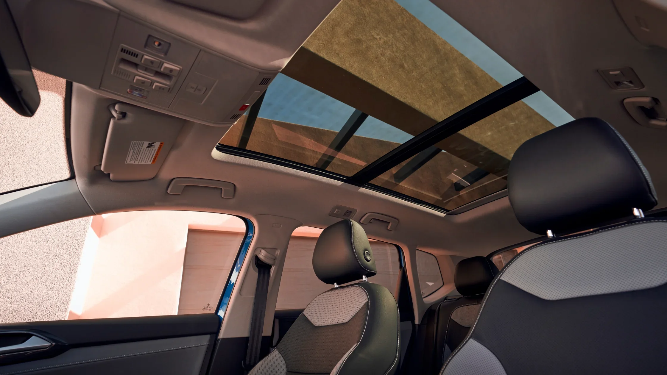 2024 Volkswagen Taos interior with panoramic sunroof and stylish seating.