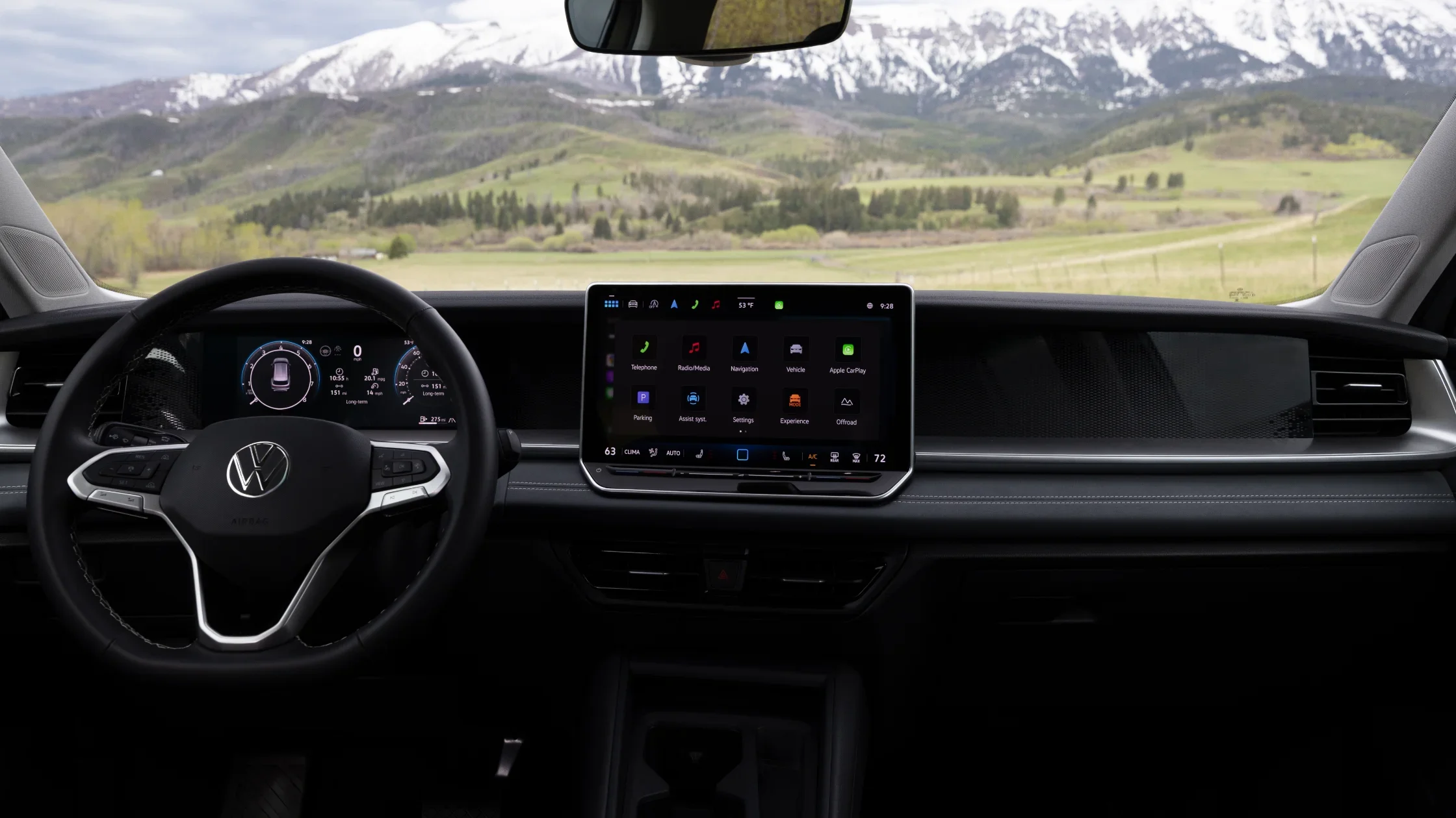 Interior view of 2025 Volkswagen Tiguan dashboard with digital display and mountain scenery outside.