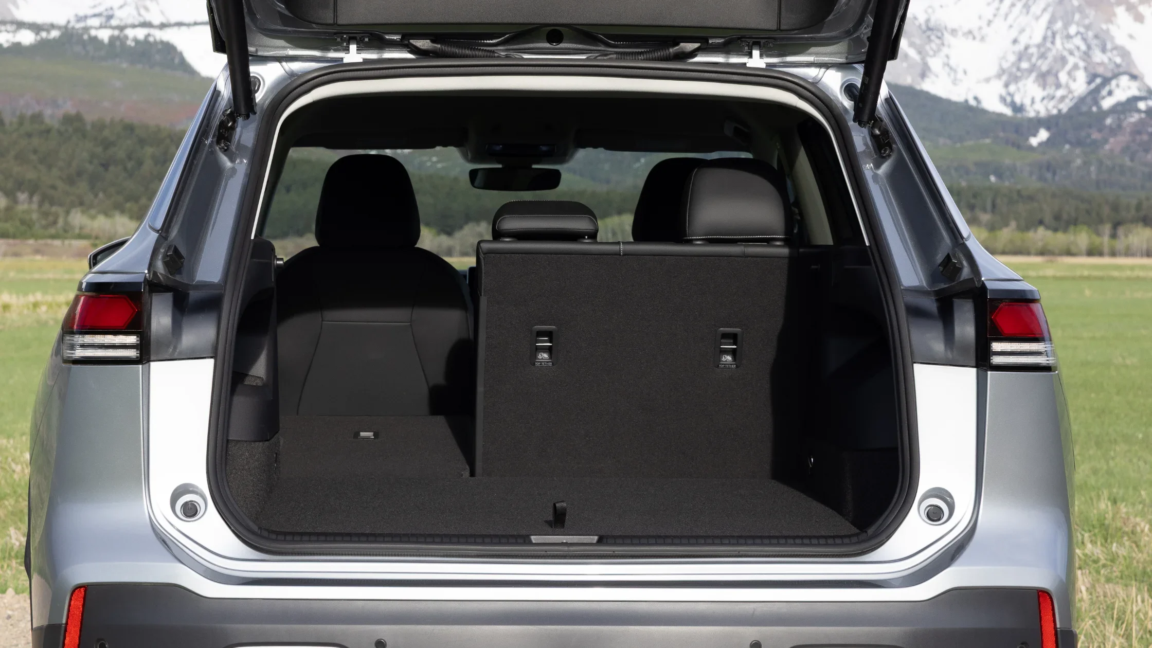 Open rear cargo space of 2025 Volkswagen Tiguan showing split-folding seats and spacious storage area.
