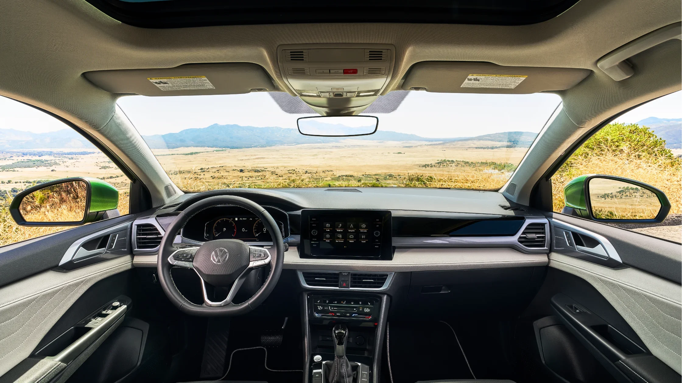 Interior view of the 2025 Volkswagen Taos with dashboard and scenic view.