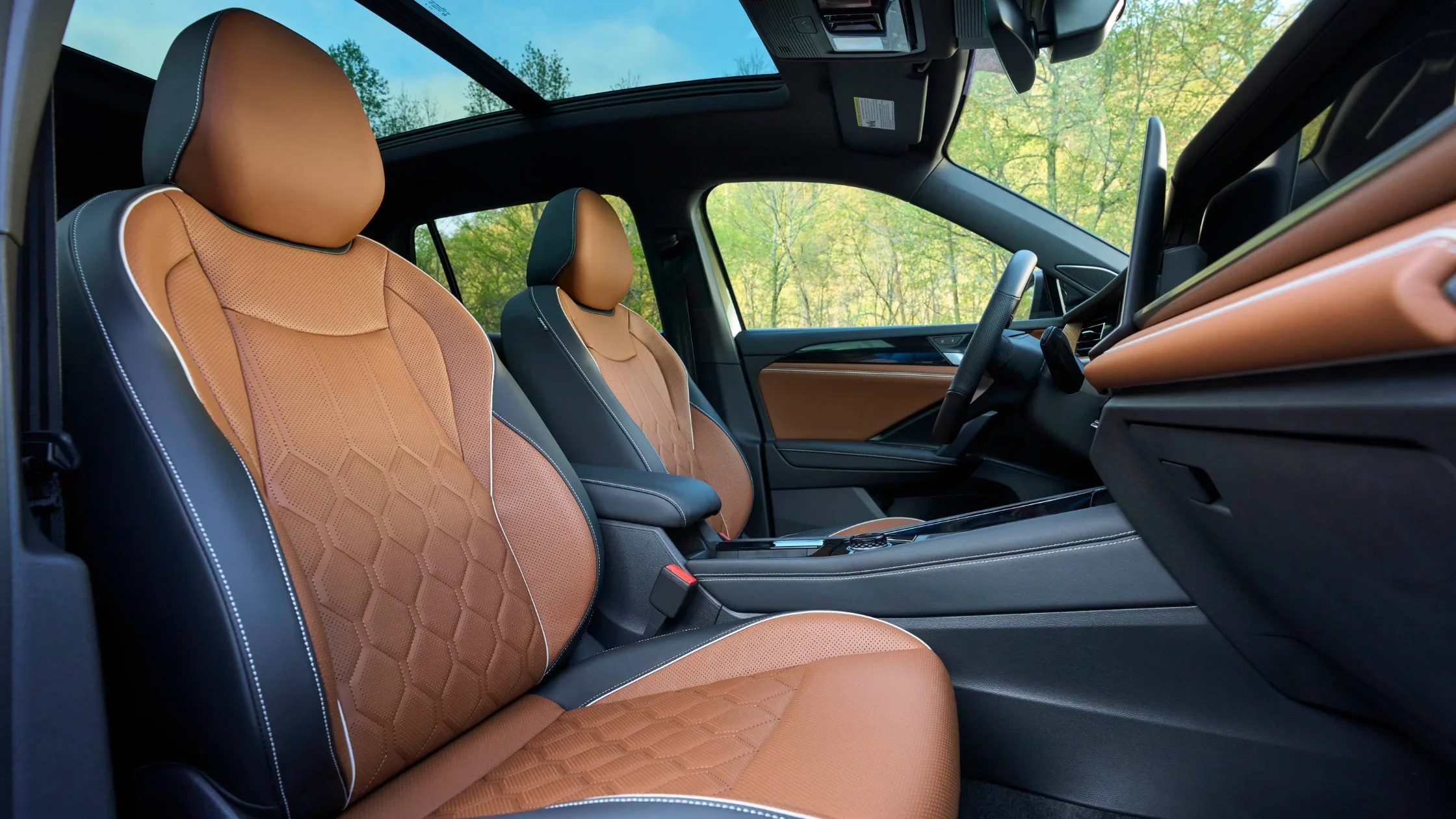Front seats of the 2026 Volkswagen Tiguan SEL R-Line Turbo with brown leather and panoramic sunroof.