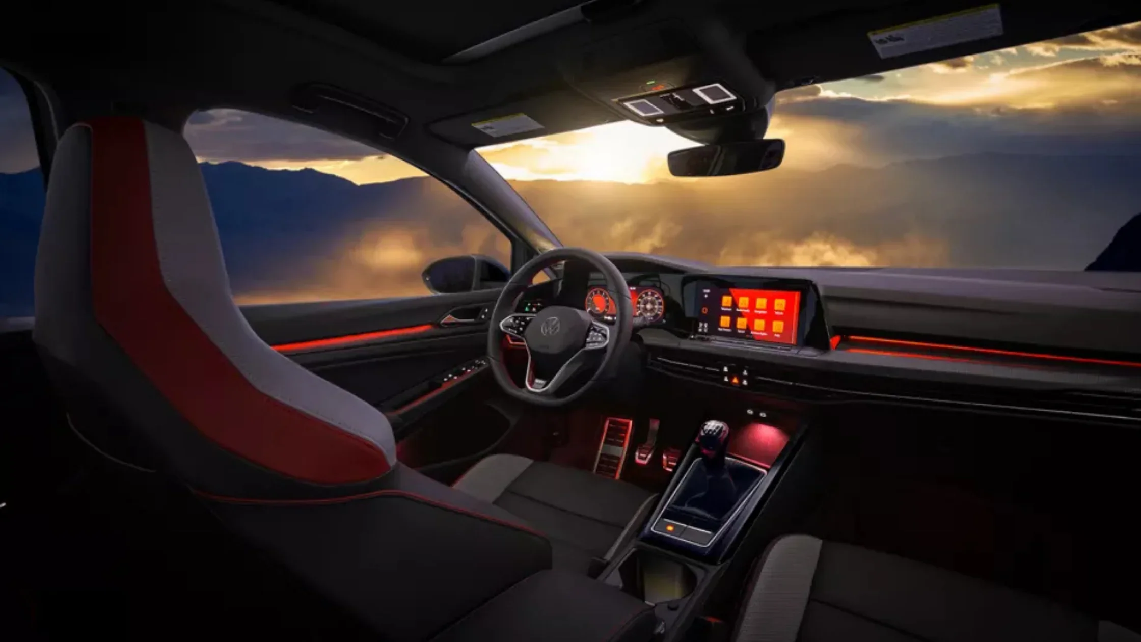 The 2025 Volkswagen Golf GTI interior with ambient red lighting and a digital dashboard.