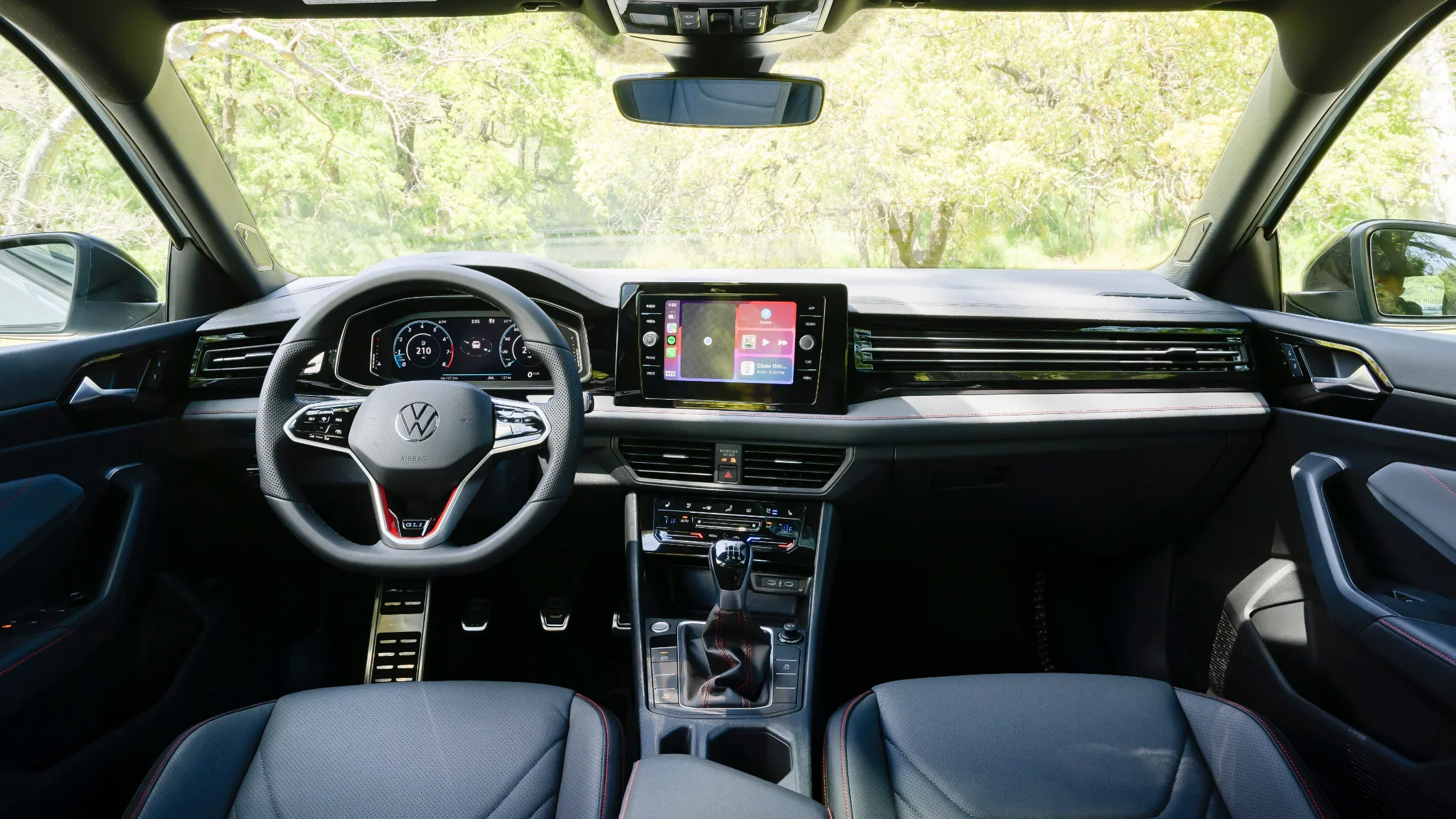 The interior of a Volkswagen Jetta GLI with a digital dashboard and infotainment screen.