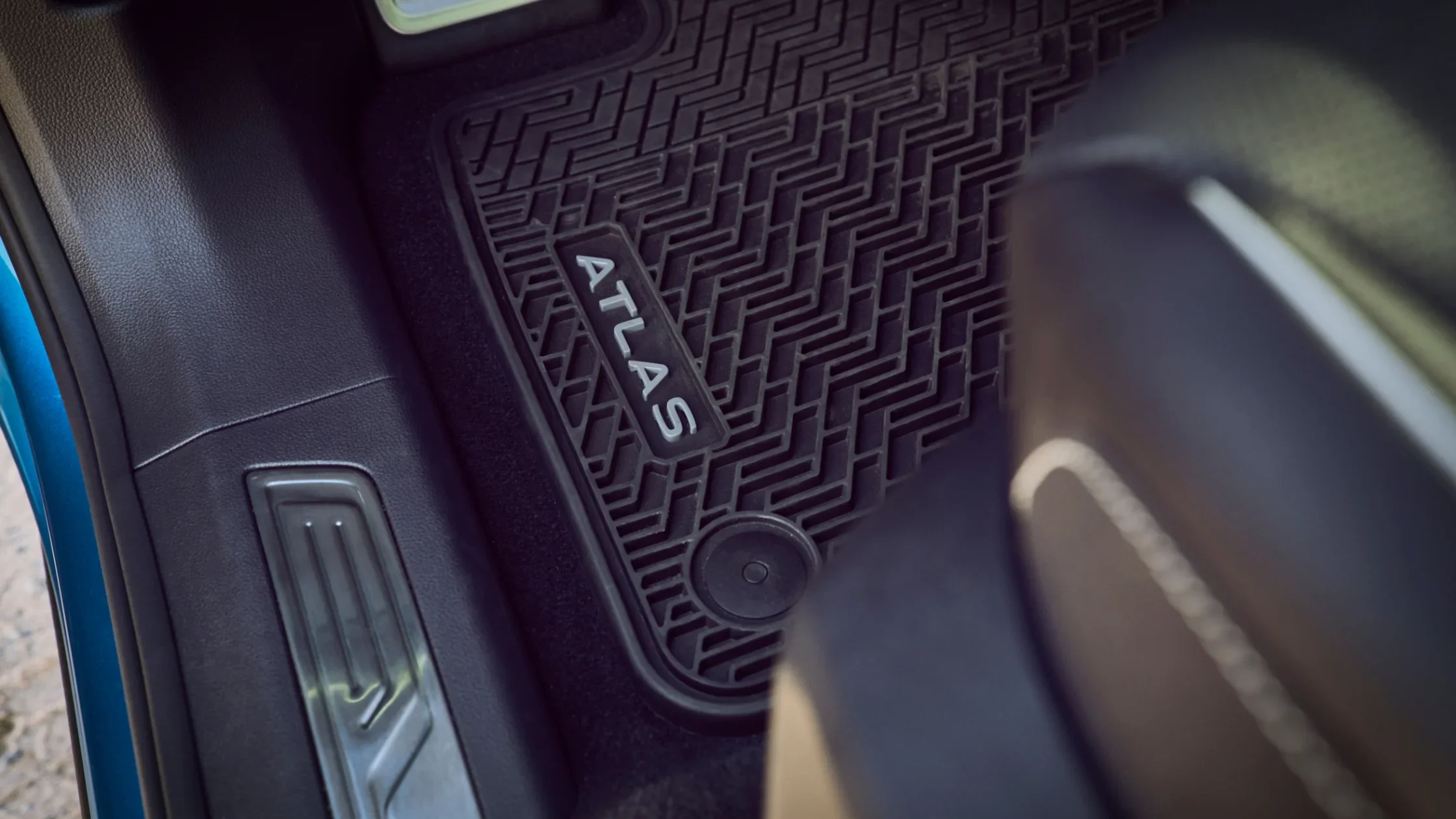 Close-up of the custom rubber floor mat with “Atlas” branding inside the 2025 Volkswagen Atlas Cross Sport.