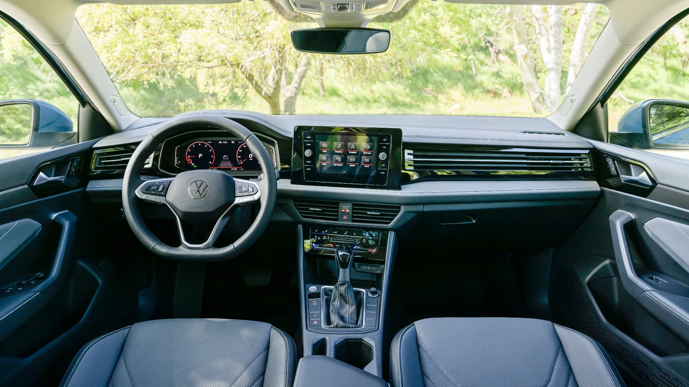 Interior view of the 2025 Volkswagen Jetta showcasing the steering wheel, digital instrument cluster, touchscreen infotainment system, and center console.