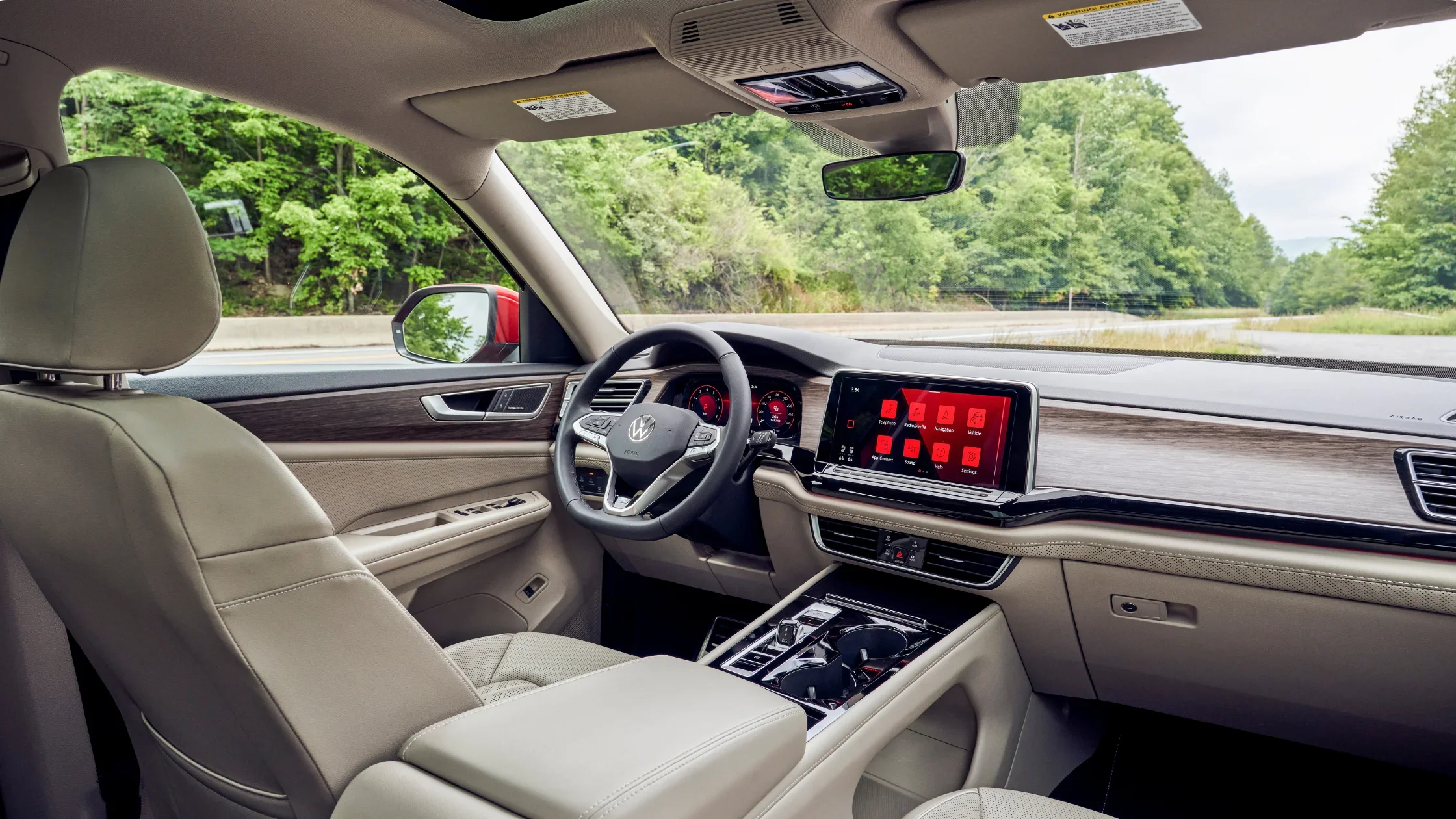 2025 Volkswagen Atlas interior with digital cockpit, wood trim accents and spacious front seating.
