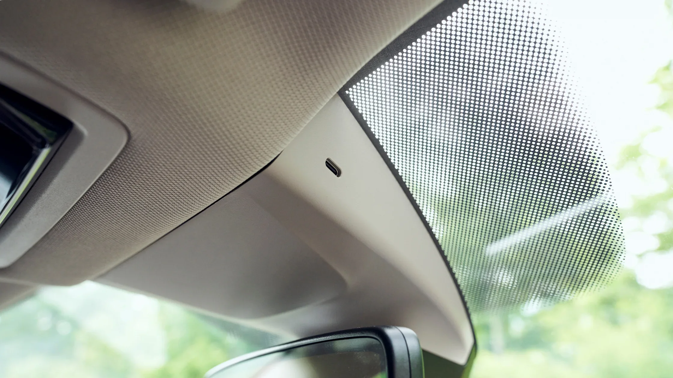 2025 Volkswagen Atlas cabin detail showing windshield sensor and upper interior trim finish.