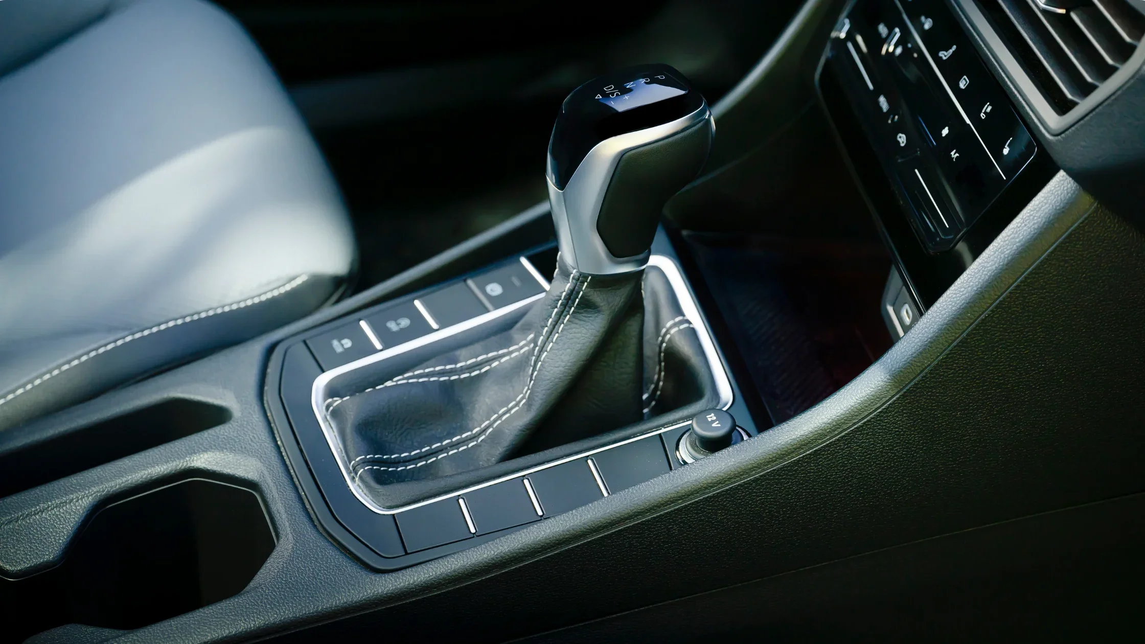 2025 Volkswagen Jetta gear shifter detail with stitched leather boot and center console layout.