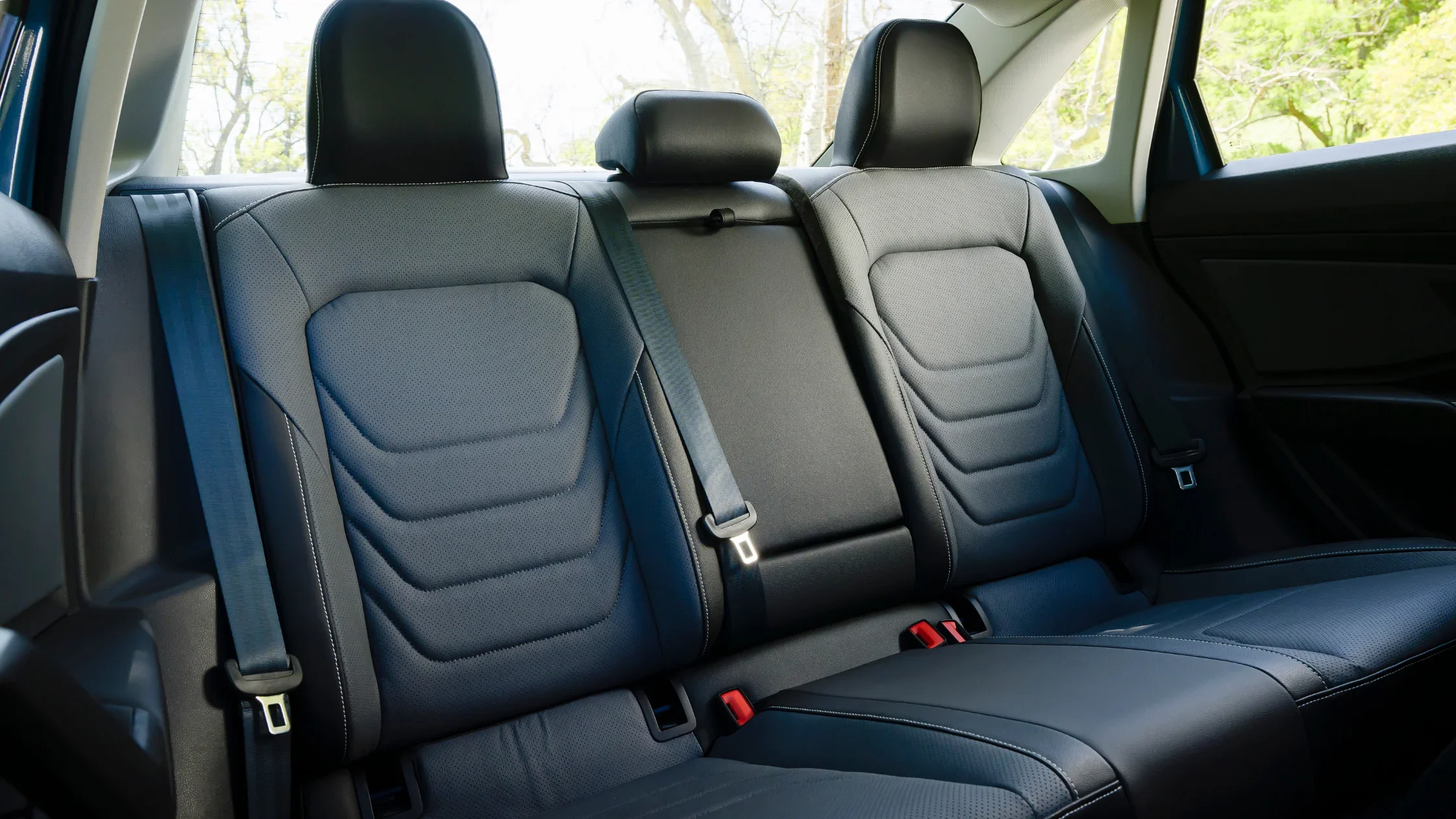 2025 Volkswagen Jetta rear seats with black upholstery, stitched detailing and seatbelt setup.