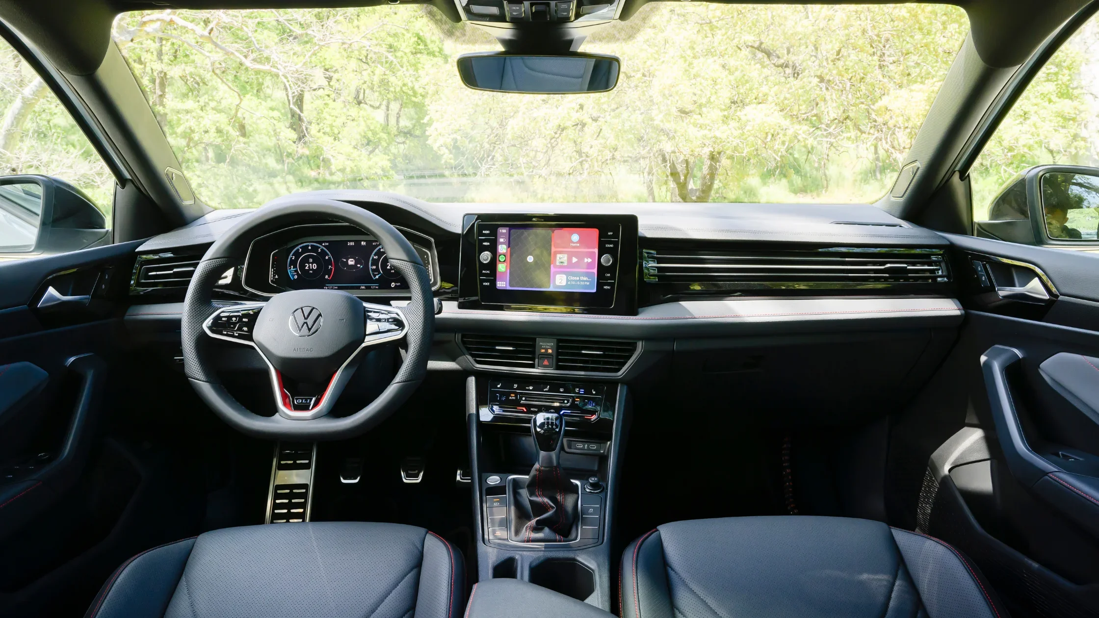 Driver’s cockpit of the 2026 Volkswagen Jetta GLI showcasing steering wheel and digital gauges.