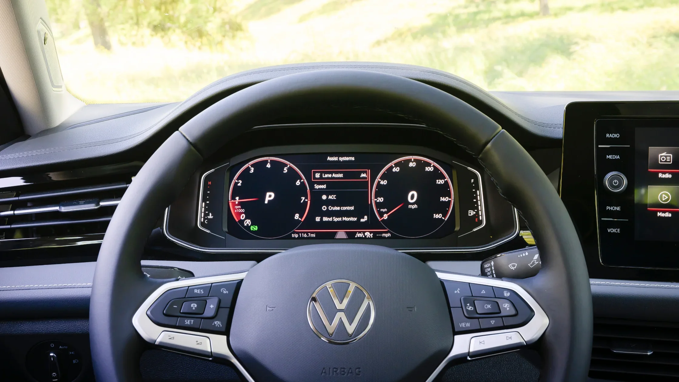 Cockpit of the 2026 Volkswagen Jetta showing steering wheel and digital instrument cluster display.