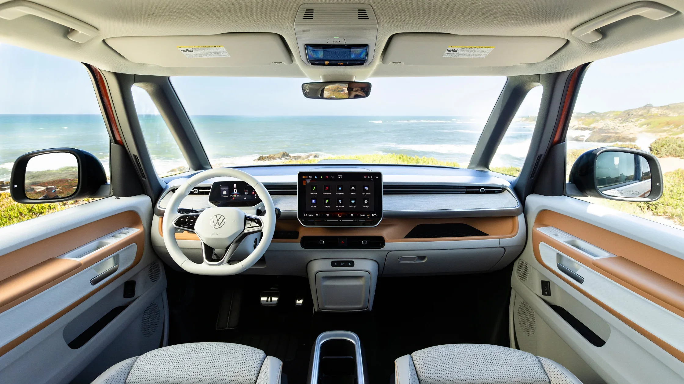 2025 Volkswagen ID. Buzz front interior with digital cockpit and panoramic ocean view.