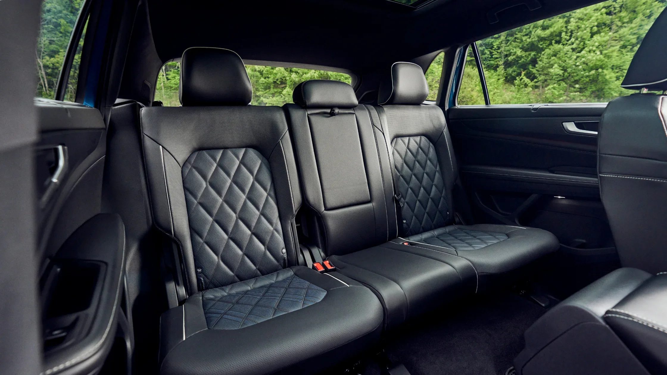 2026 Volkswagen Atlas Cross Sport rear seat interior with black quilted upholstery.