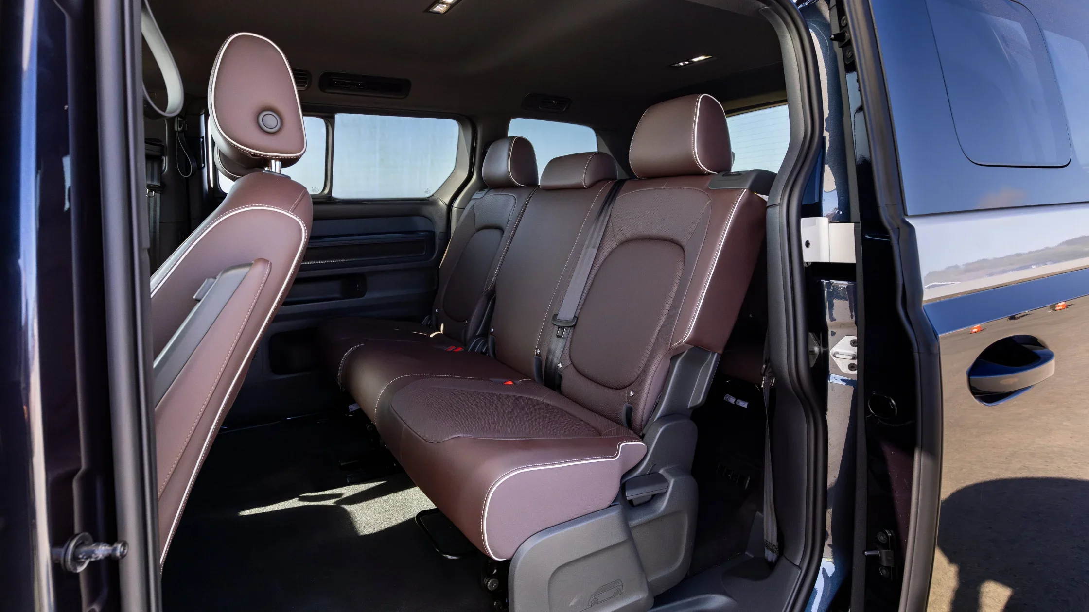 Rear passenger seats of the 2025 Volkswagen ID. Buzz with brown upholstery.