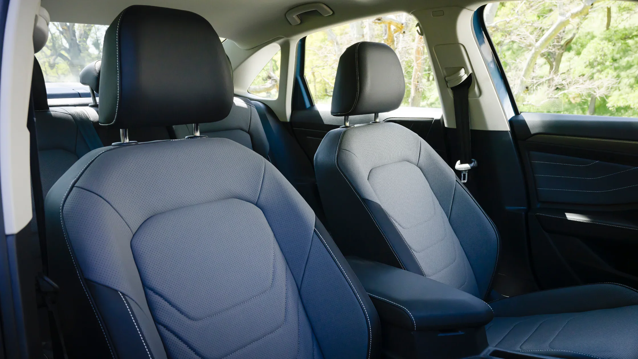 Front seats of the 2025 Volkswagen Jetta with black leather upholstery.