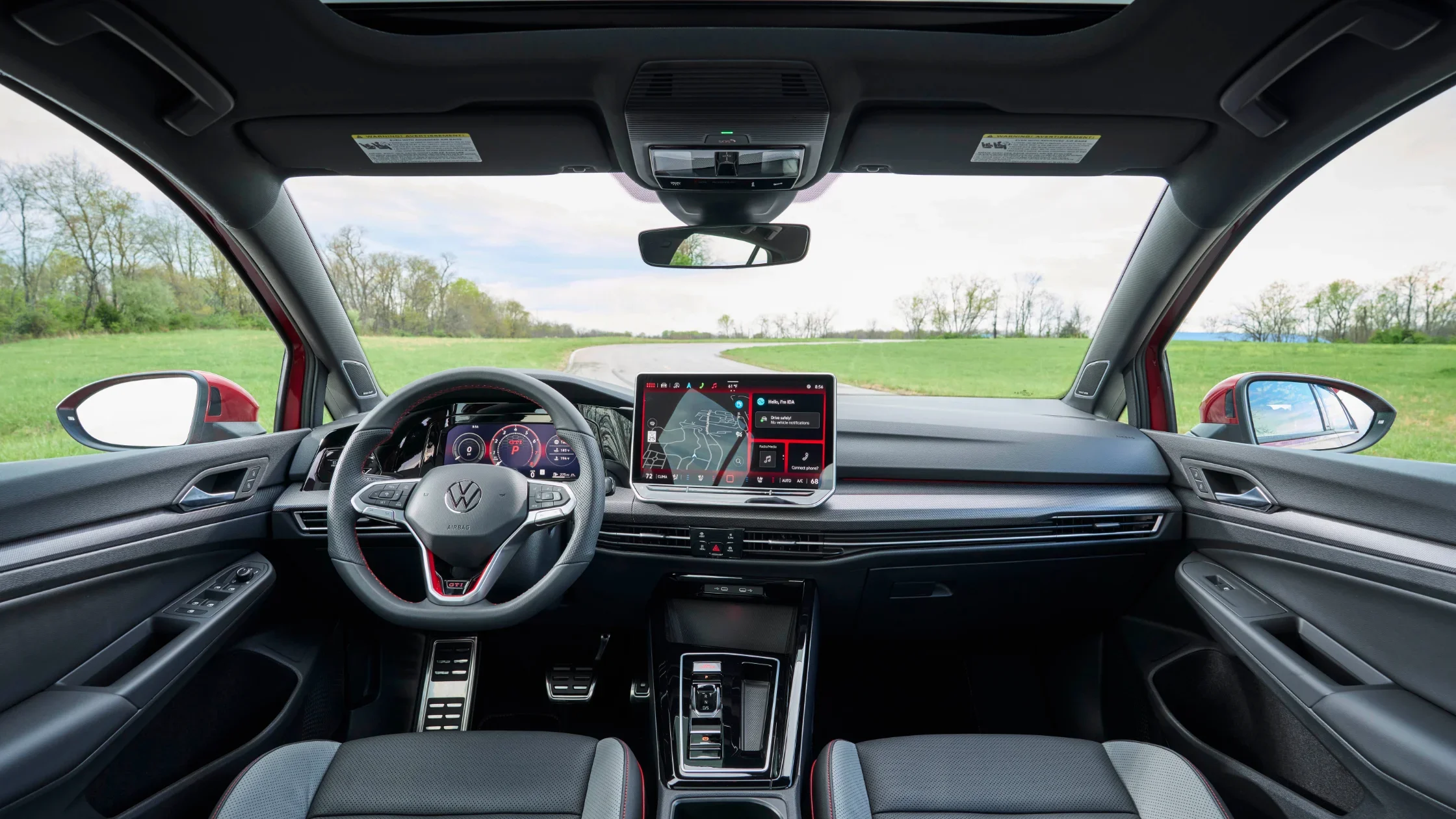 2025 Volkswagen Golf GTI interior with steering wheel and touchscreen navigation display.