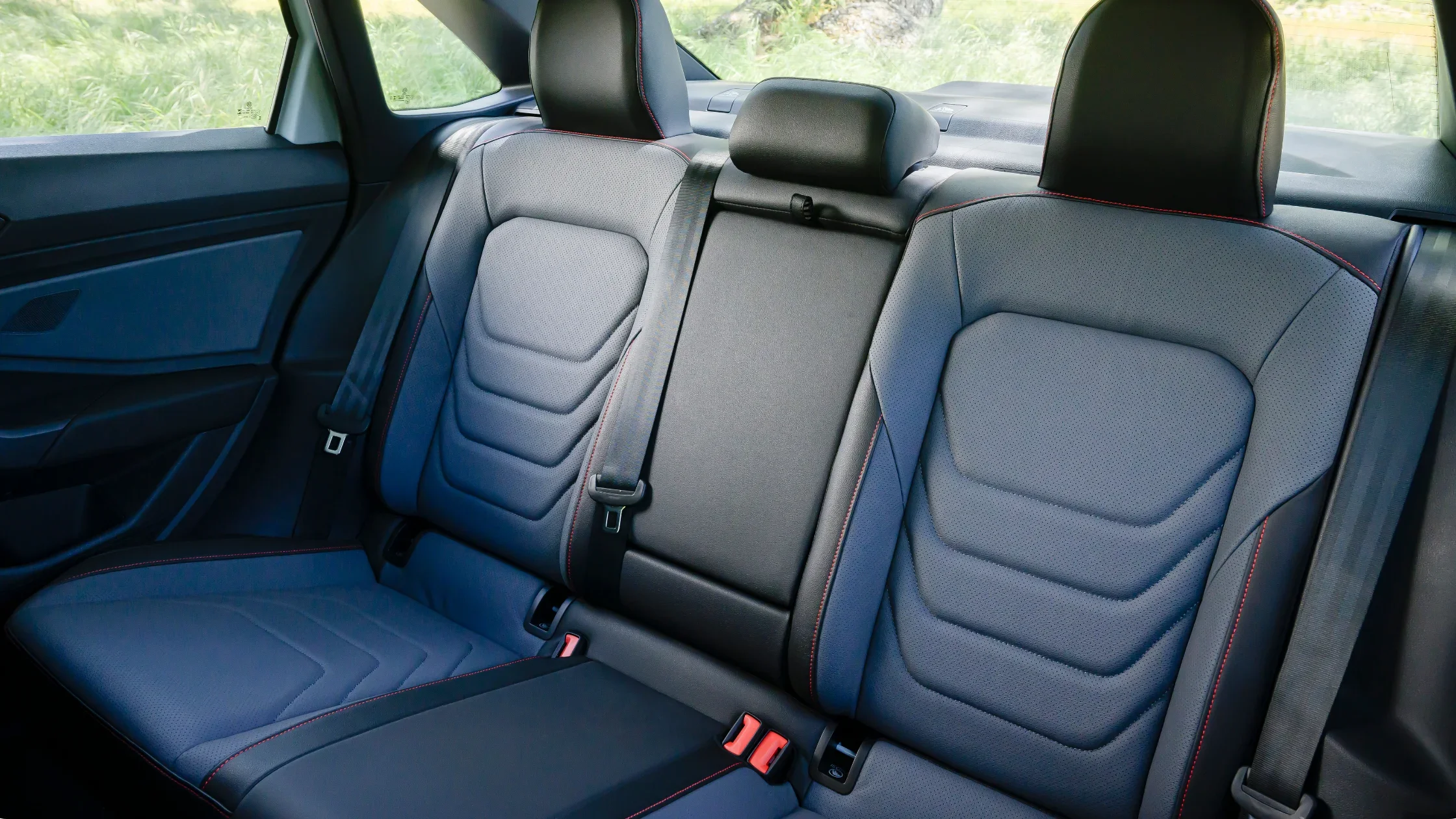 2026 Volkswagen Jetta GLI rear seat interior with black sport seats and red contrast stitching.