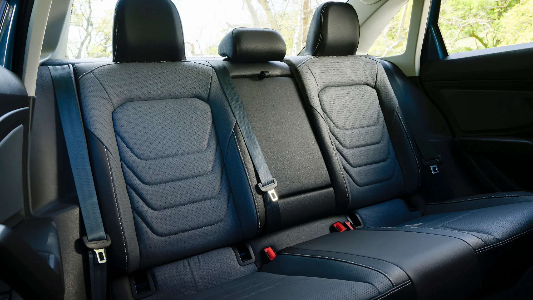 2026 Volkswagen Jetta rear seat interior with black leather seating and center armrest folded up.