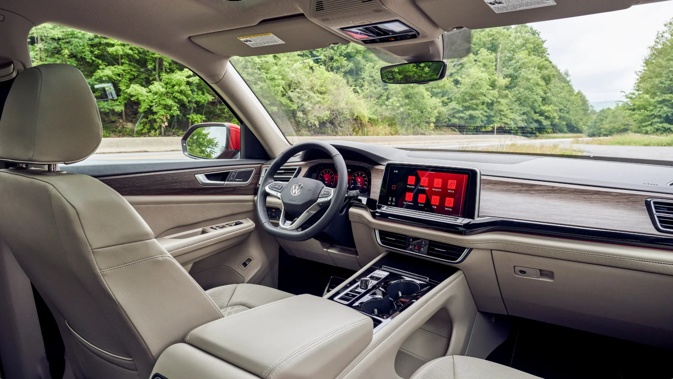 Interior view of the 2025 Volkswagen Atlas showing front seats, dashboard layout, and touchscreen infotainment system.