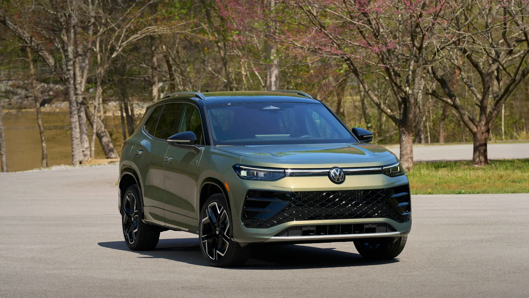 Green 2026 Volkswagen Tiguan SEL R-Line Turbo parked outdoors, highlighting sporty grille, wheels, and exterior design.