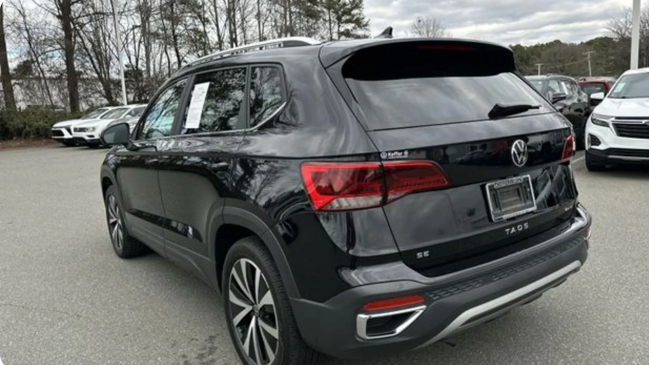 Certified Pre-Owned Volkswagen Taos rear three quarter view showing LED tail lights and compact SUV styling.