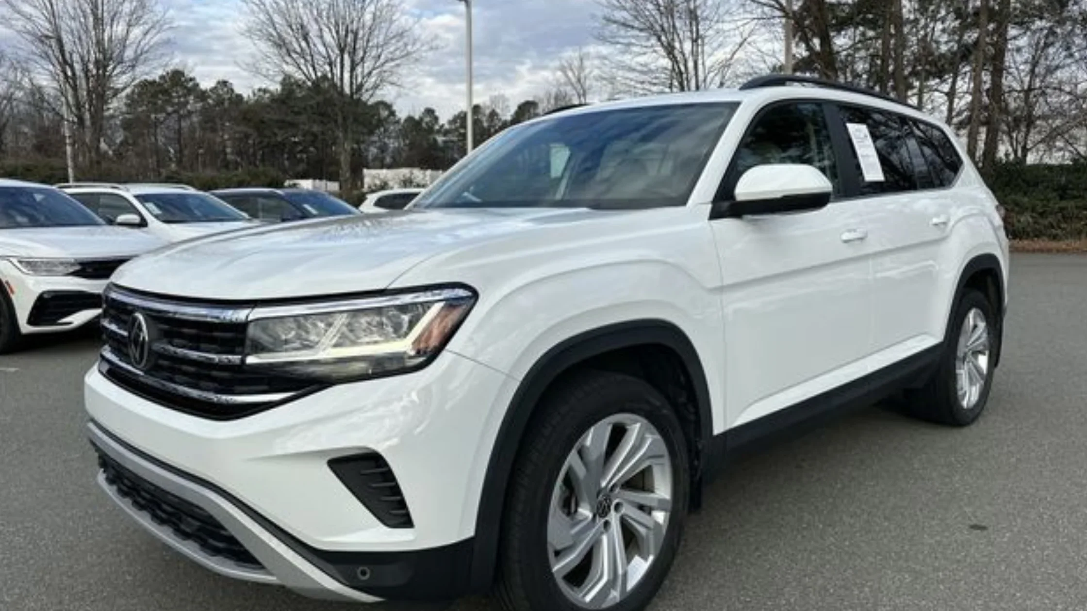 Volkswagen Certified Pre-Owned SUV lineup parked at dealership lot showcasing inspected pre-owned Volkswagen vehicles.